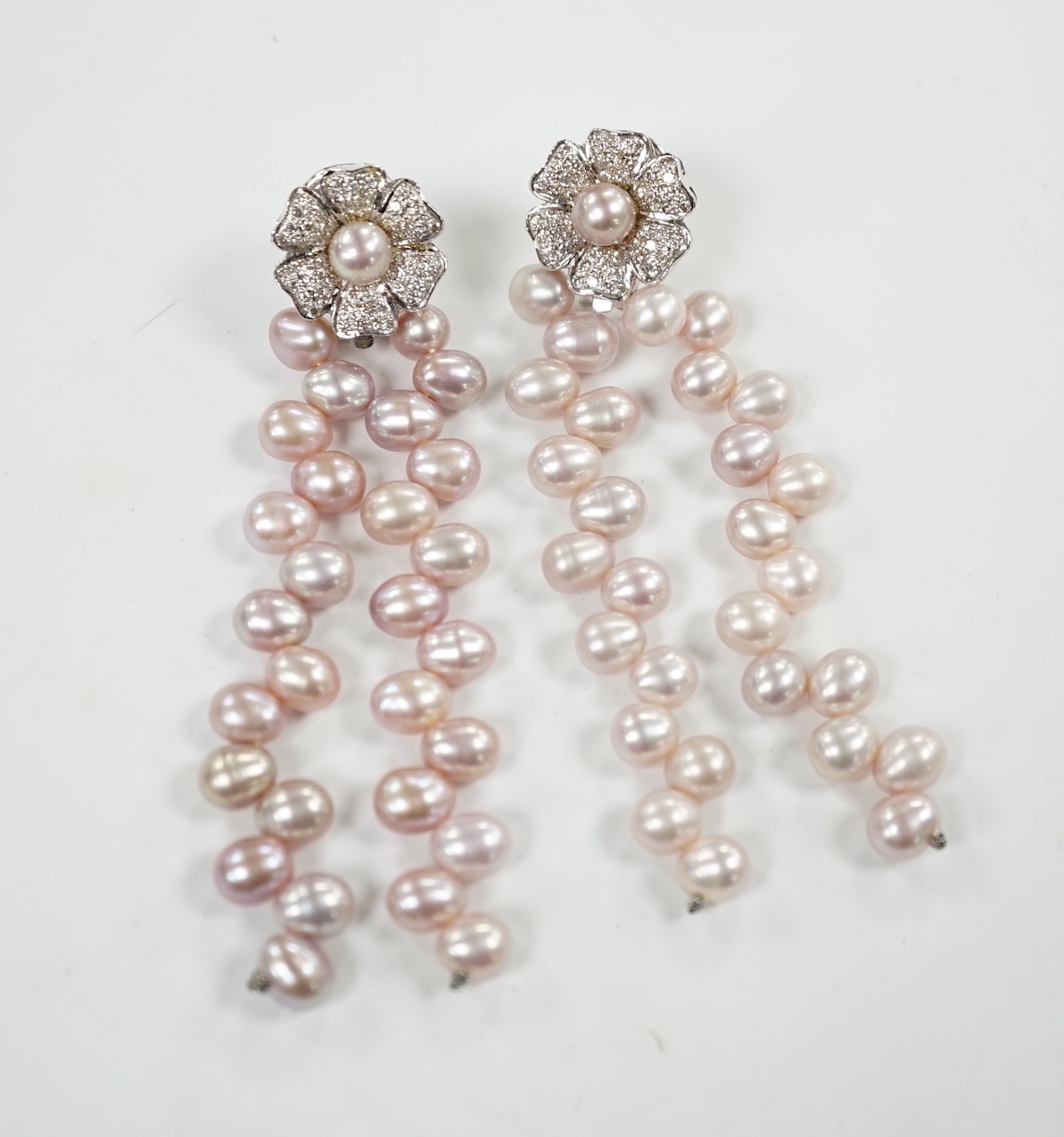 A modern pair of white metal, diamond chip cluster and three row pink cultured pearl tassel drop earrings, 91mm.